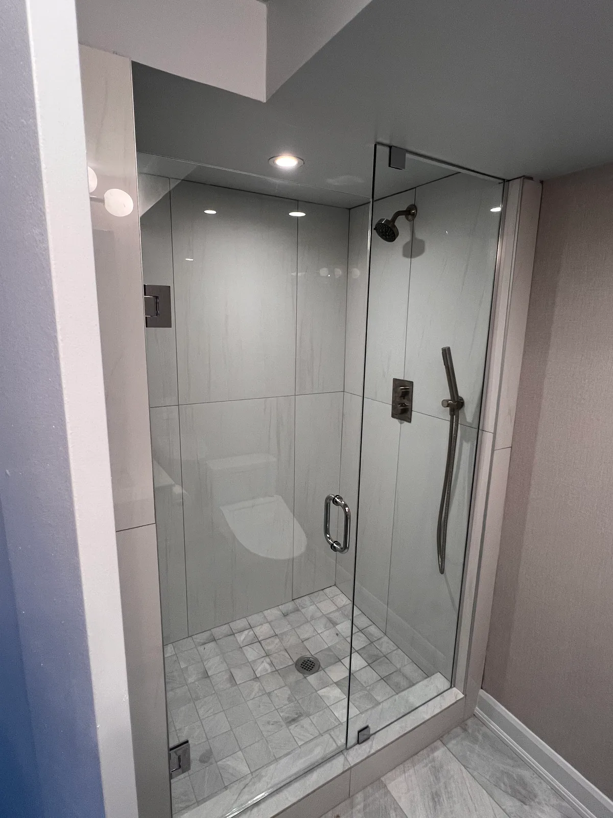 Glass-enclosed shower with tiled walls at 3000 Bathurst