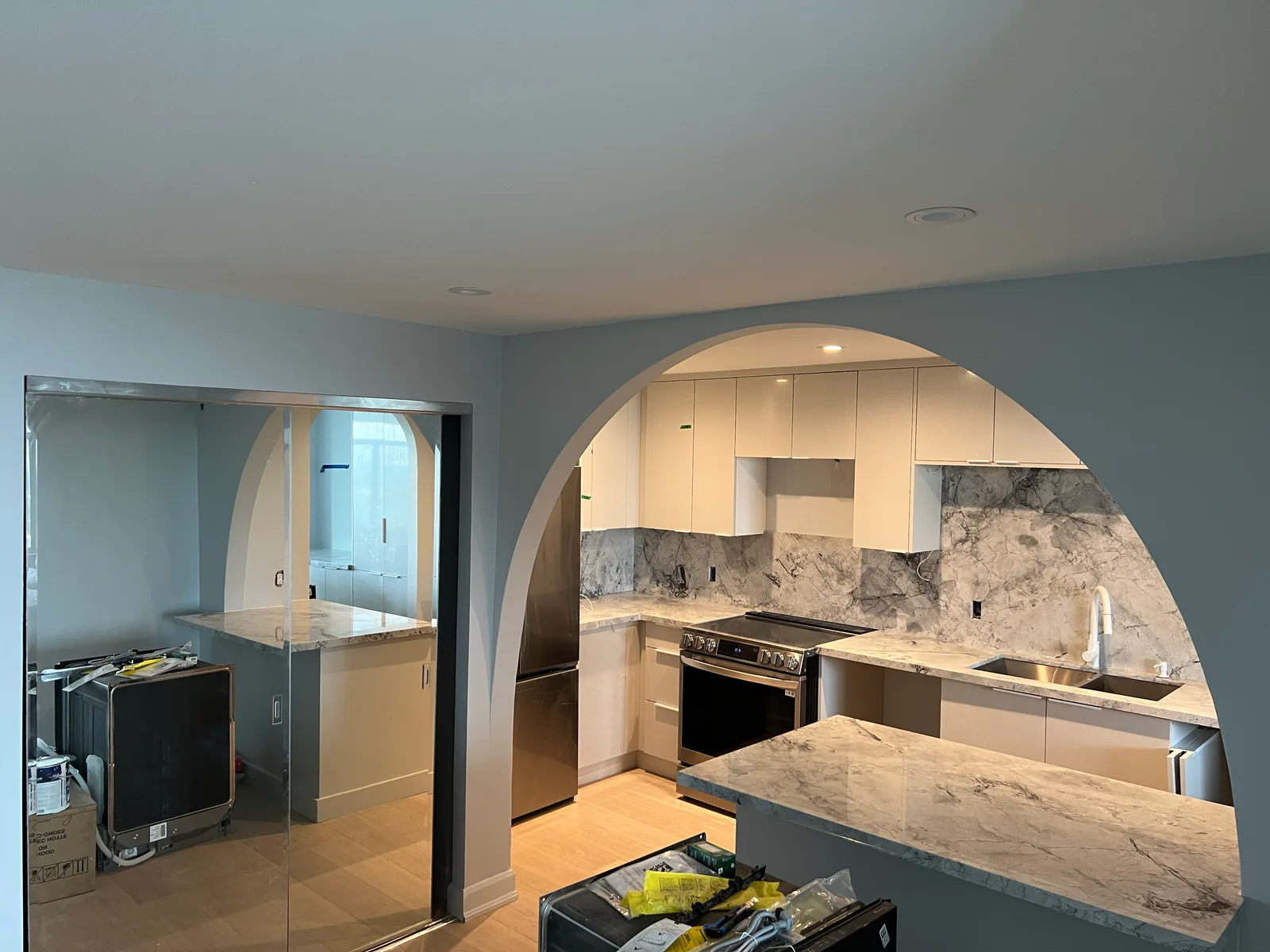Wide view of the completed kitchen arch and open living area at 3000 Bathurst