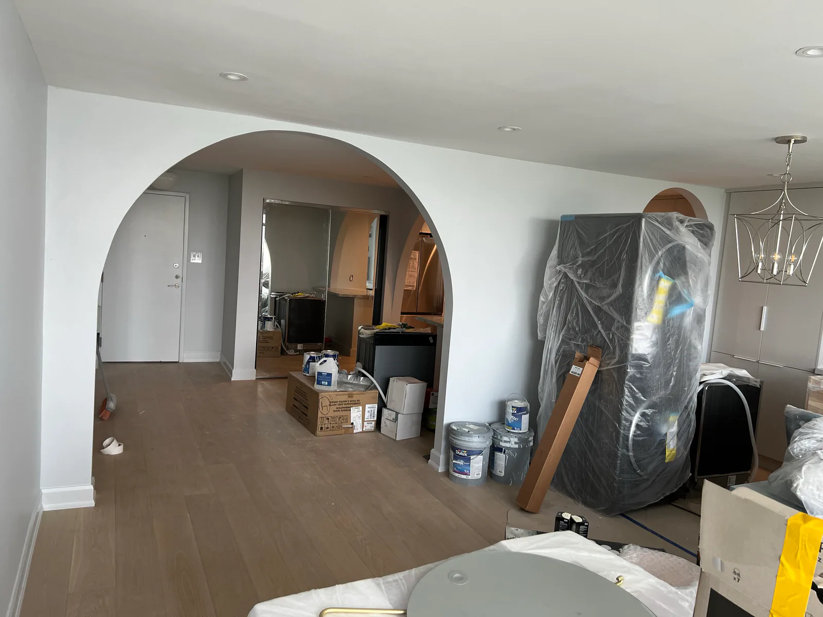 Finished dining and living area with arched openings at 3000 Bathurst