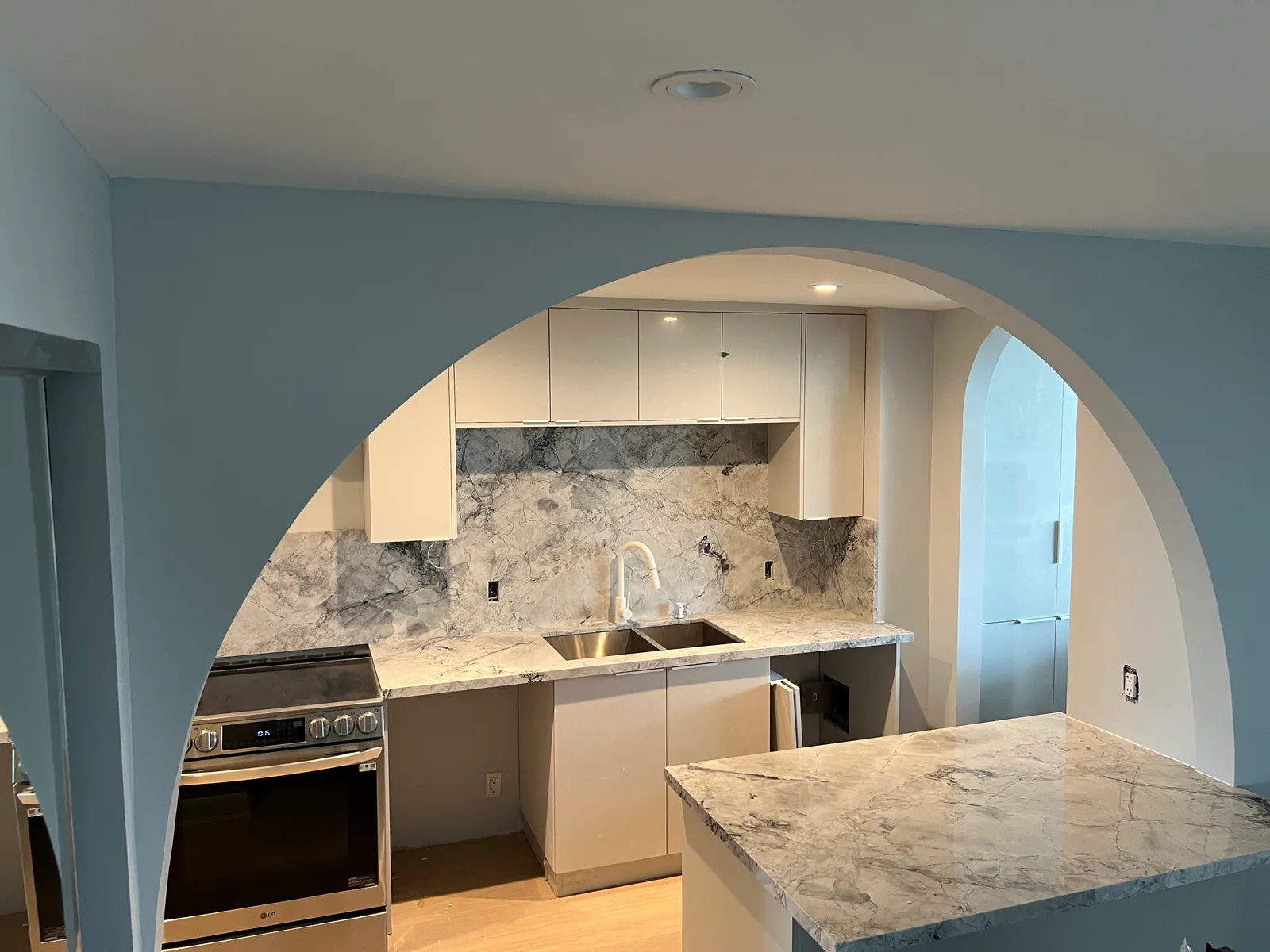 Finished kitchen island, lighting, and flooring at 3000 Bathurst