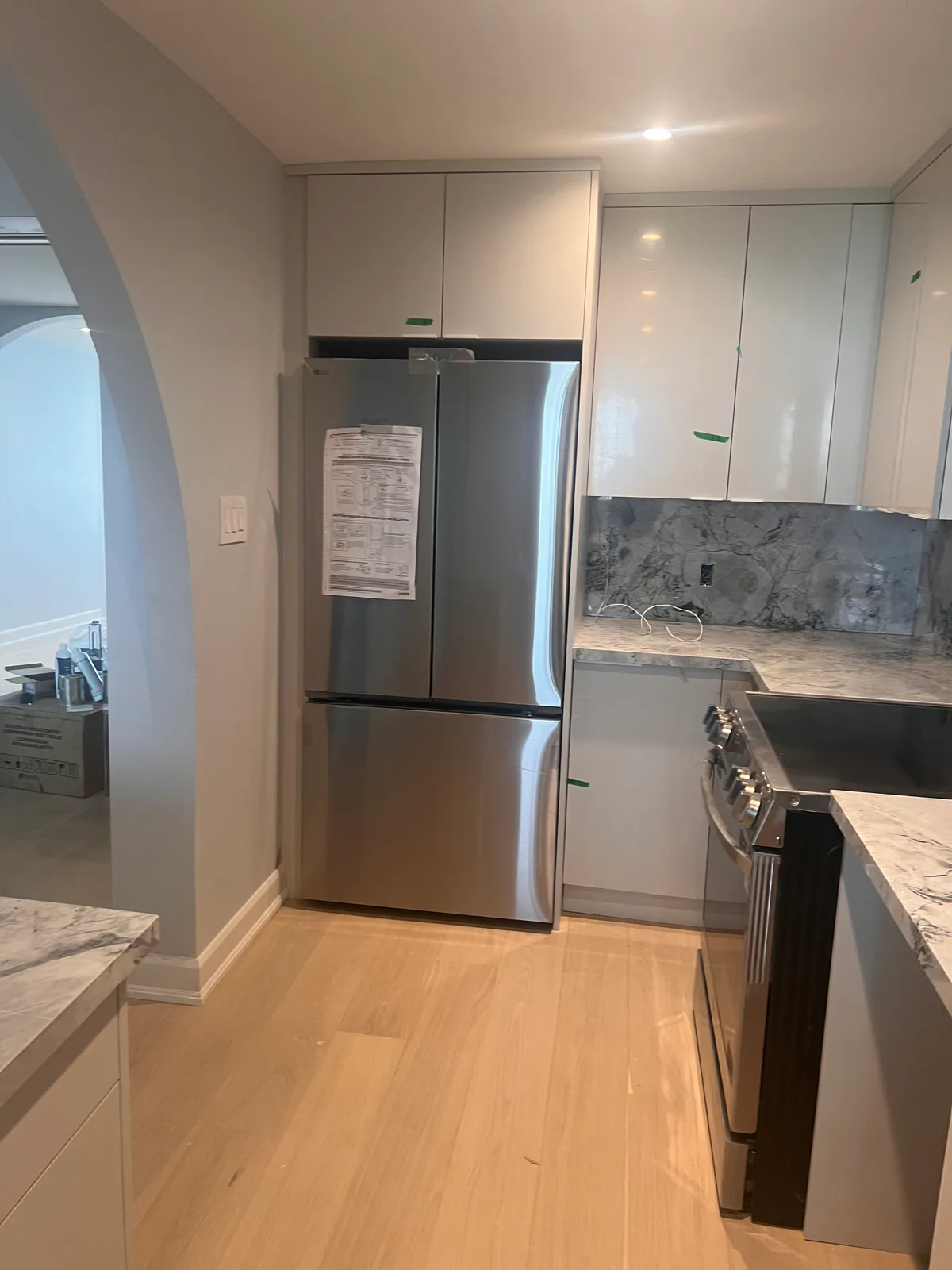 Completed refrigerator wall and light wood flooring at 3000 Bathurst