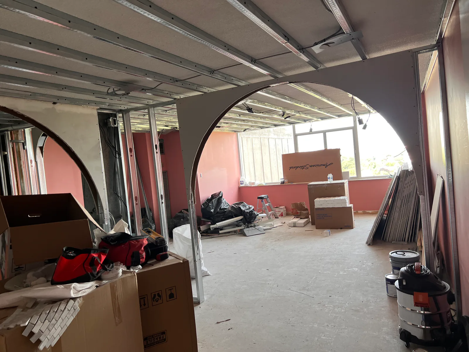 Interior renovation in progress with metal framing and curved openings at 3000 Bathurst, Toronto