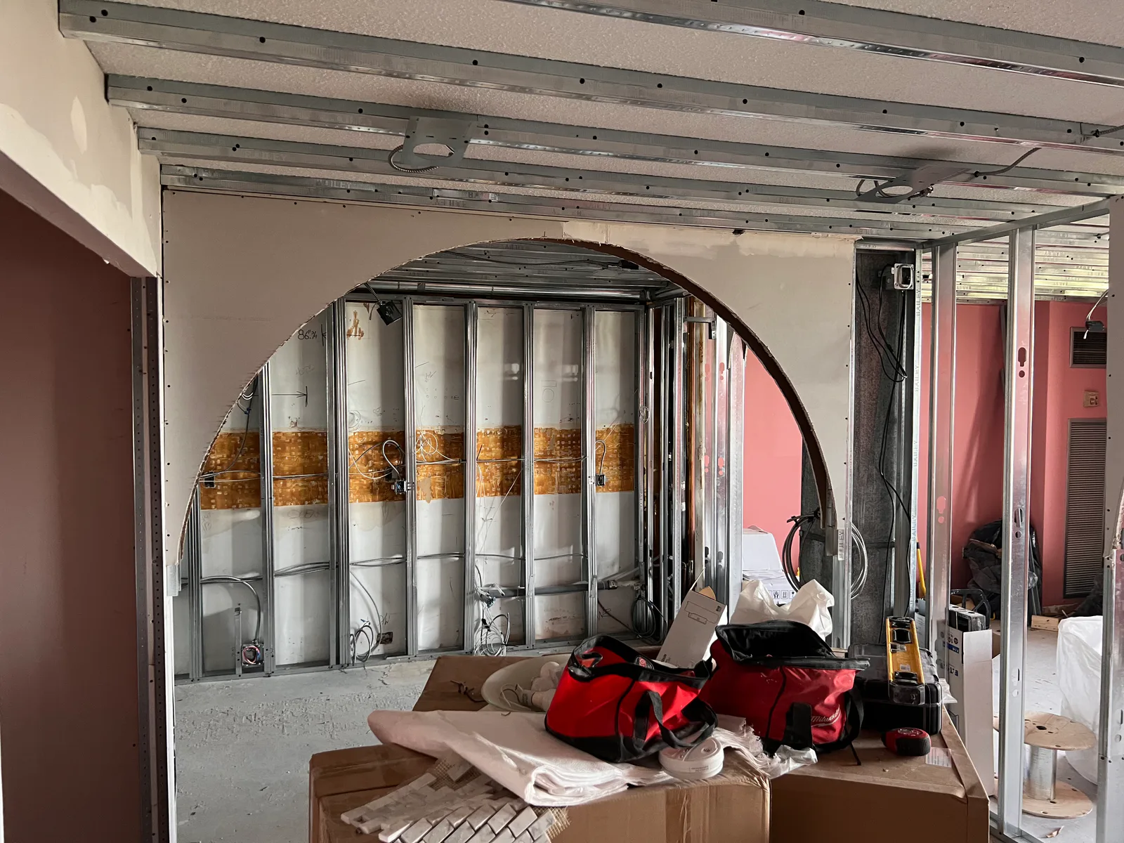 Metal studs and a curved drywall opening during the 3000 Bathurst renovation