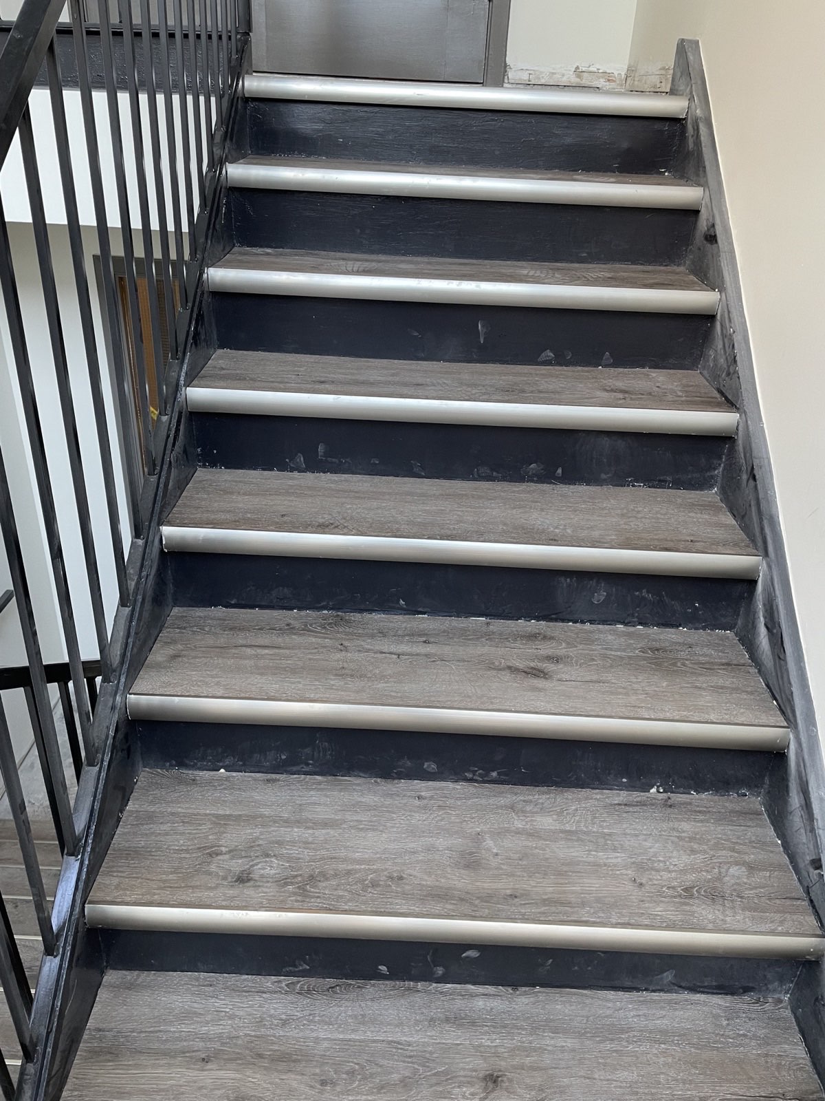 Stair treads and metal nosings during active common-area renovation work