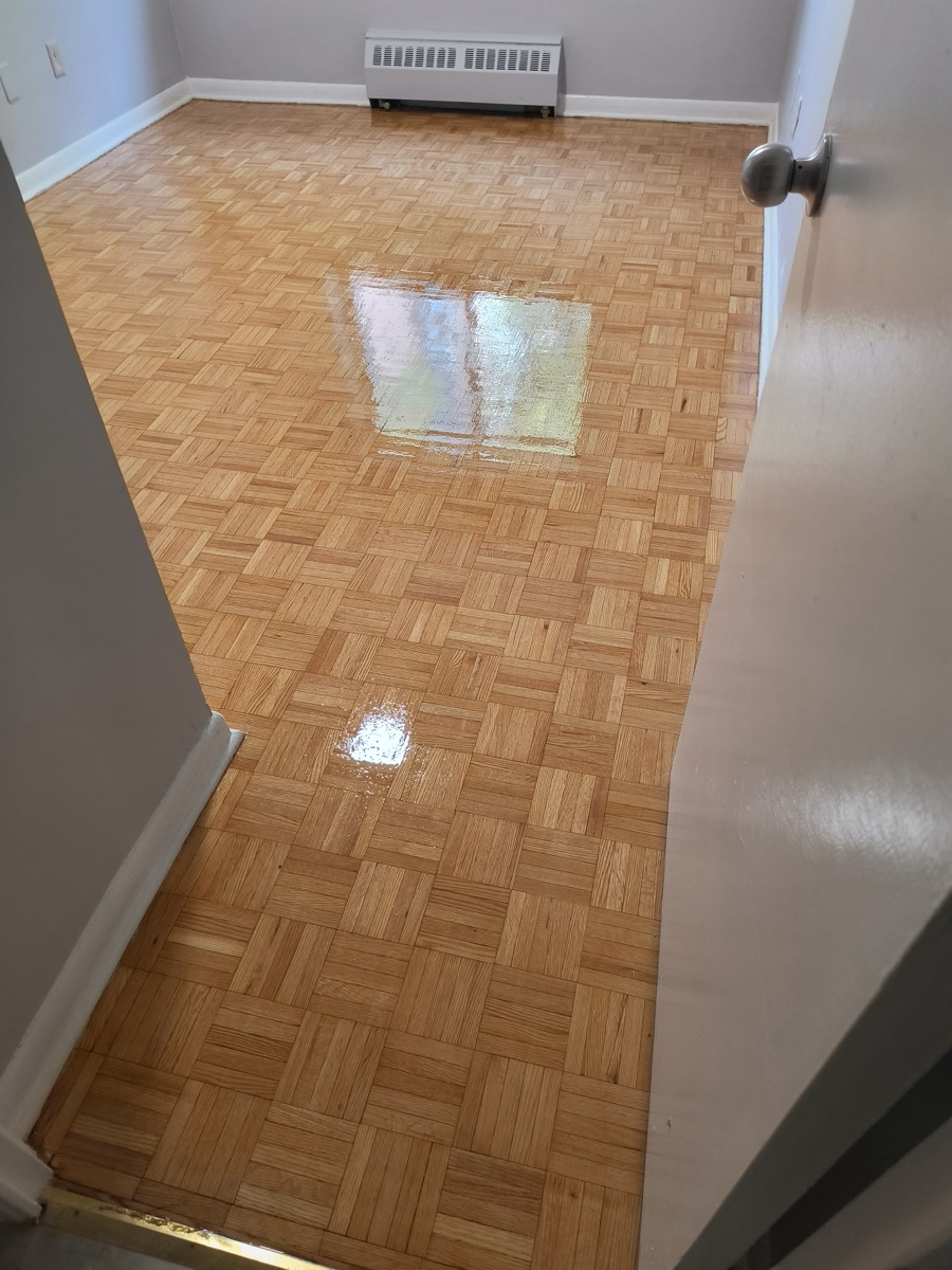 Completed parquet floor in a Dixon Road bedroom after refinishing