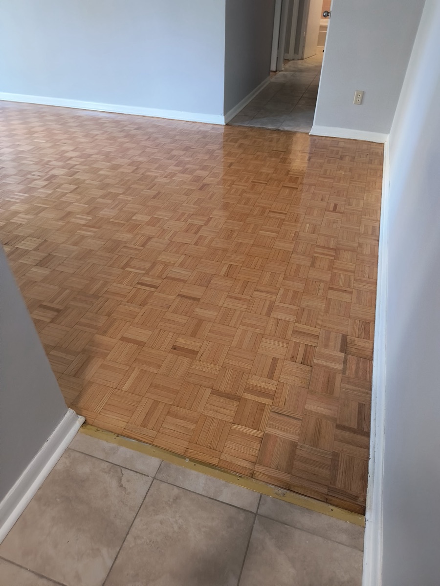 Restored parquet floor and tile threshold after sanding and finishing in Etobicoke