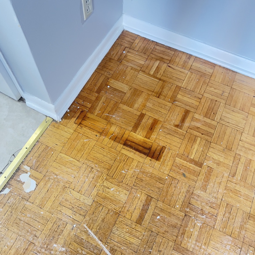 Damaged and marked parquet flooring before repair and refinishing on Dixon Road Etobicoke