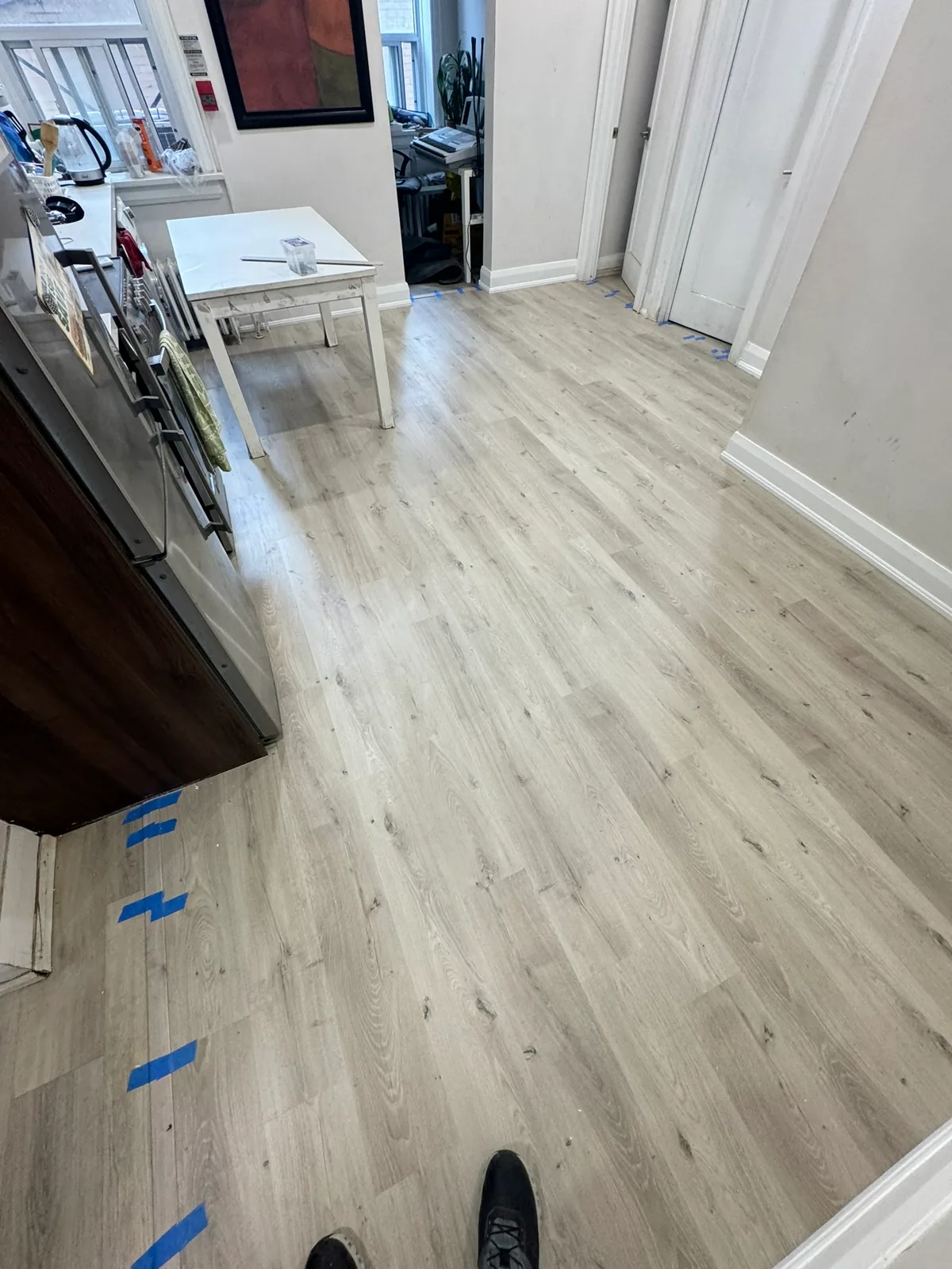 Completed flooring extending through the kitchen and hall on Eglinton Avenue West