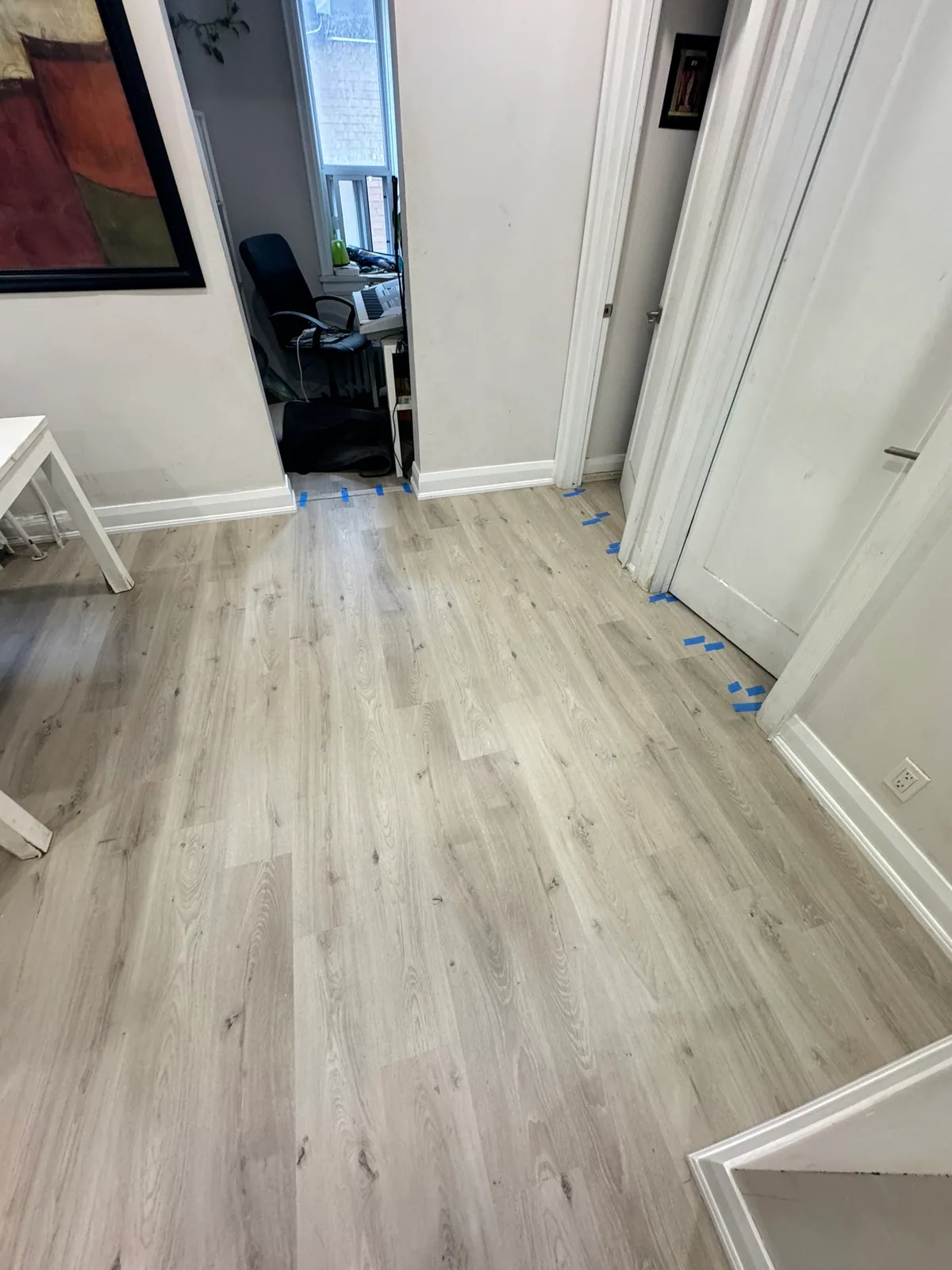 Finished flooring across the kitchen and adjoining room on Eglinton Avenue West