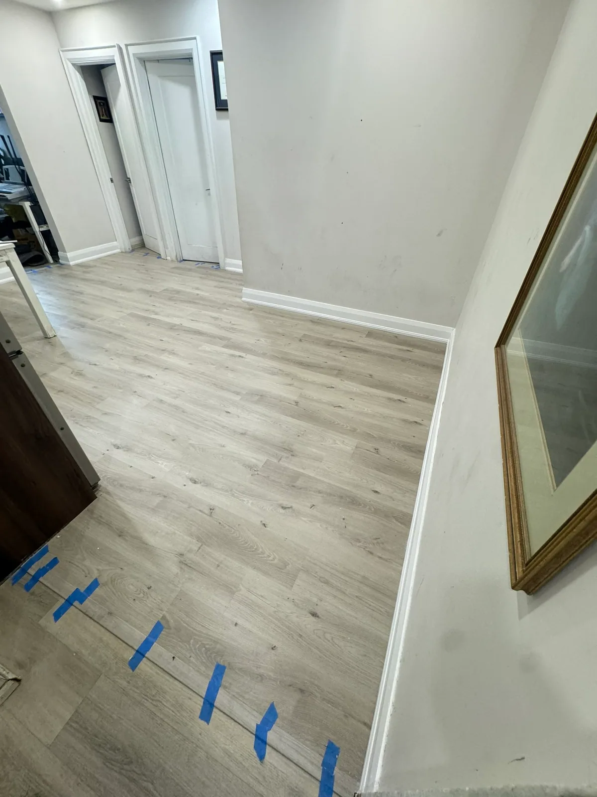 Completed plank floor viewed from the adjoining room at the Eglinton Avenue West project