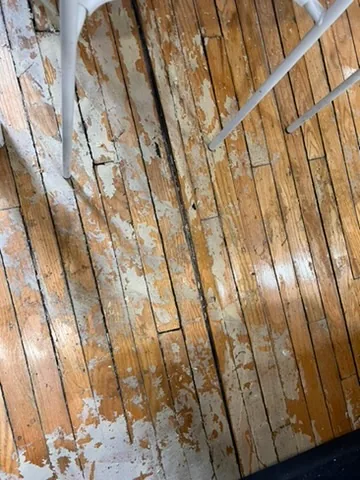 Existing worn wood floor before selective replacement at the Eglinton Avenue West project