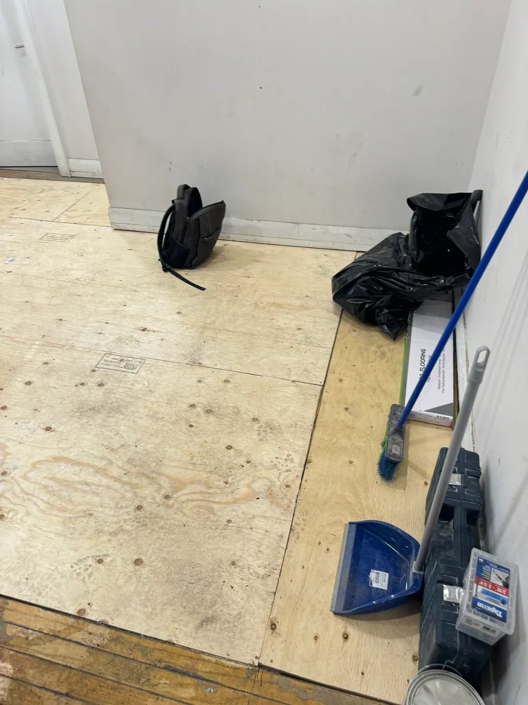 New plywood subfloor panels installed over the repaired floor area