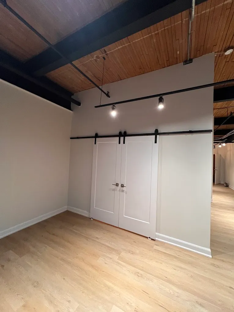 Finished interior with wood ceiling, barn doors, and new flooring