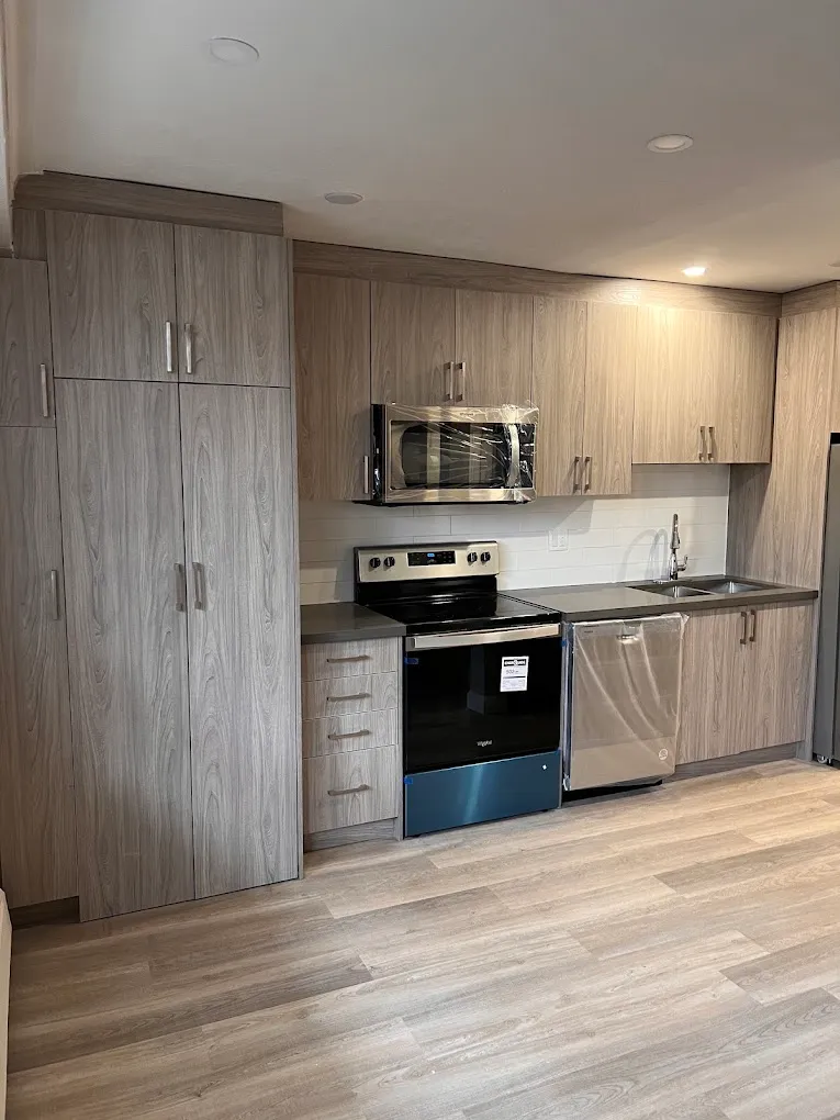 Completed kitchen with wood-grain cabinetry and new flooring