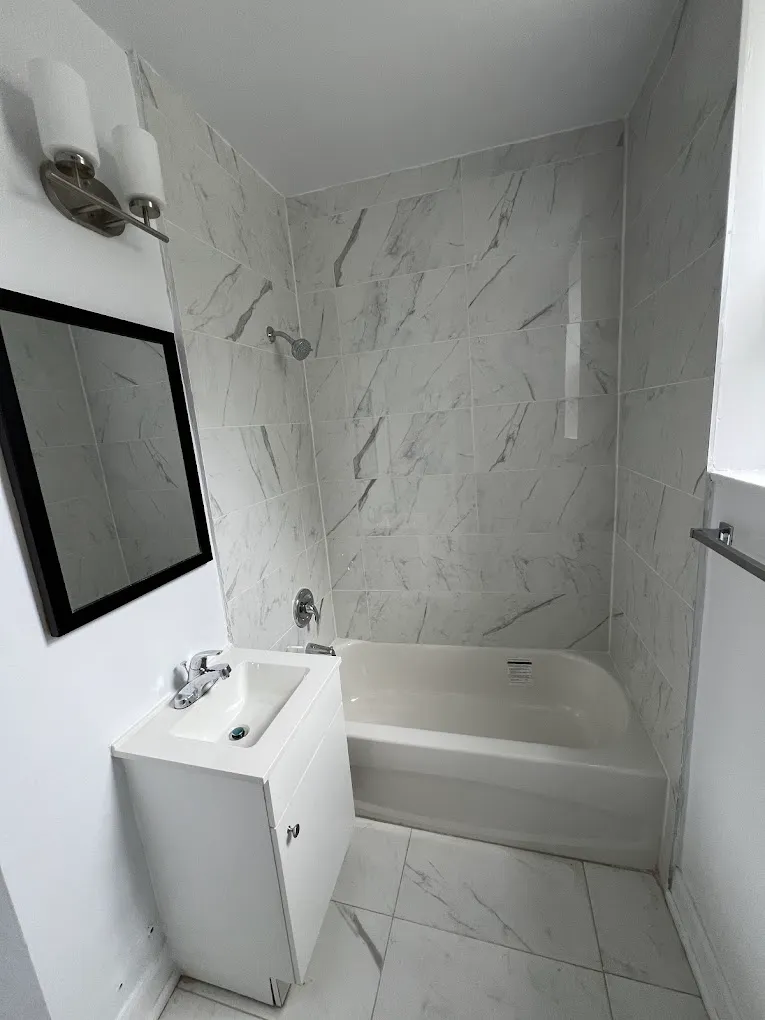Finished bathroom with marble-look tub surround