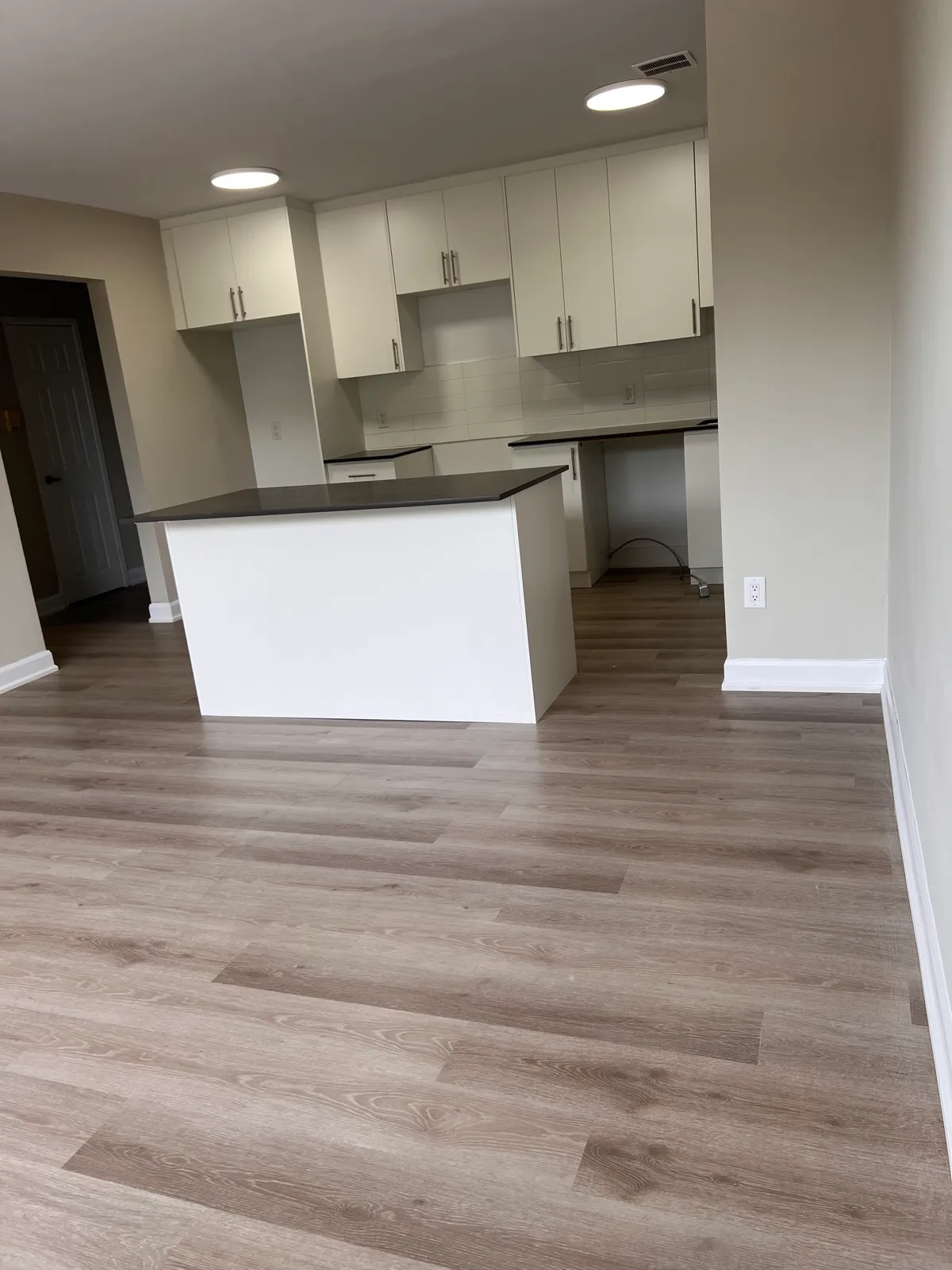 Open plan kitchen and living room with new flooring