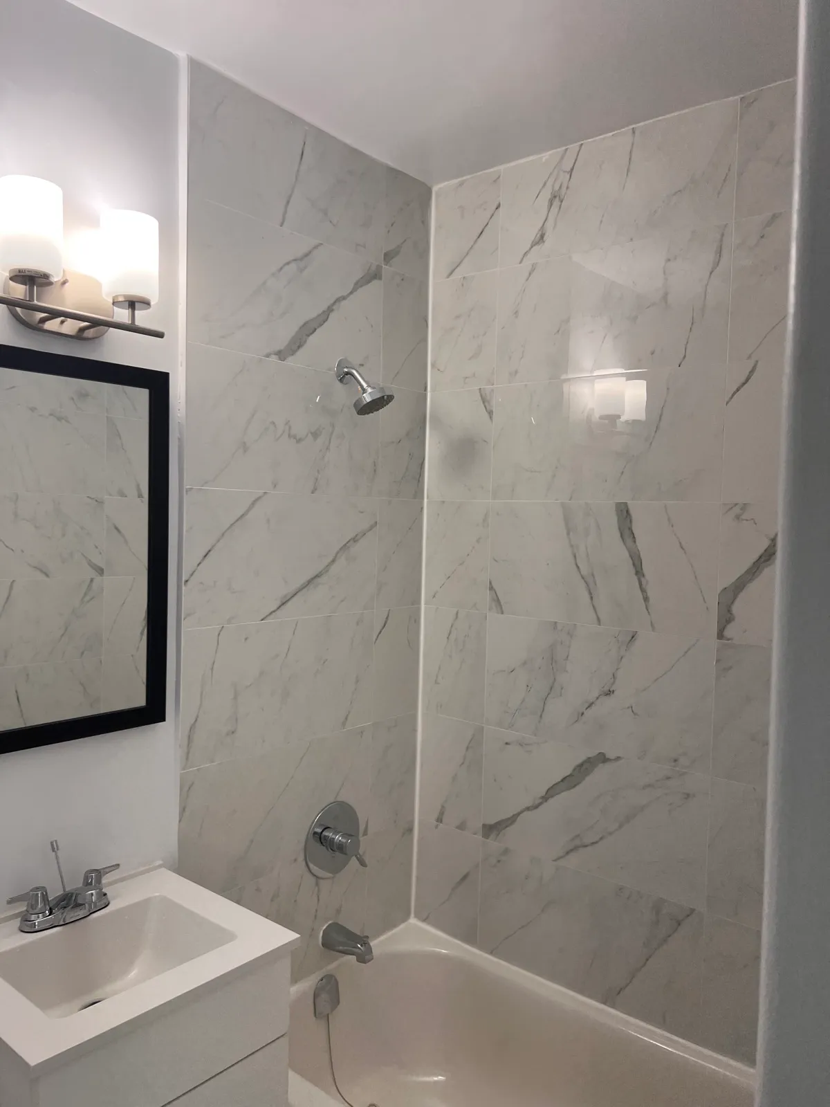 Finished bathtub with marble-look wall tile