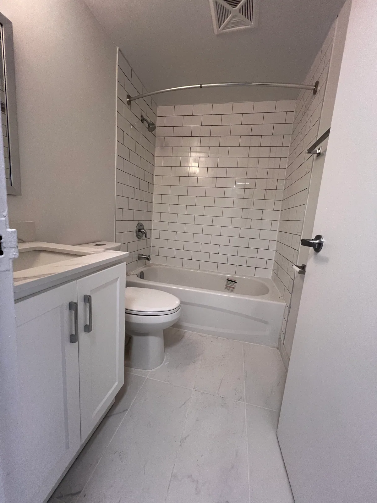 Completed Brampton condo bathroom with large-format floor tile