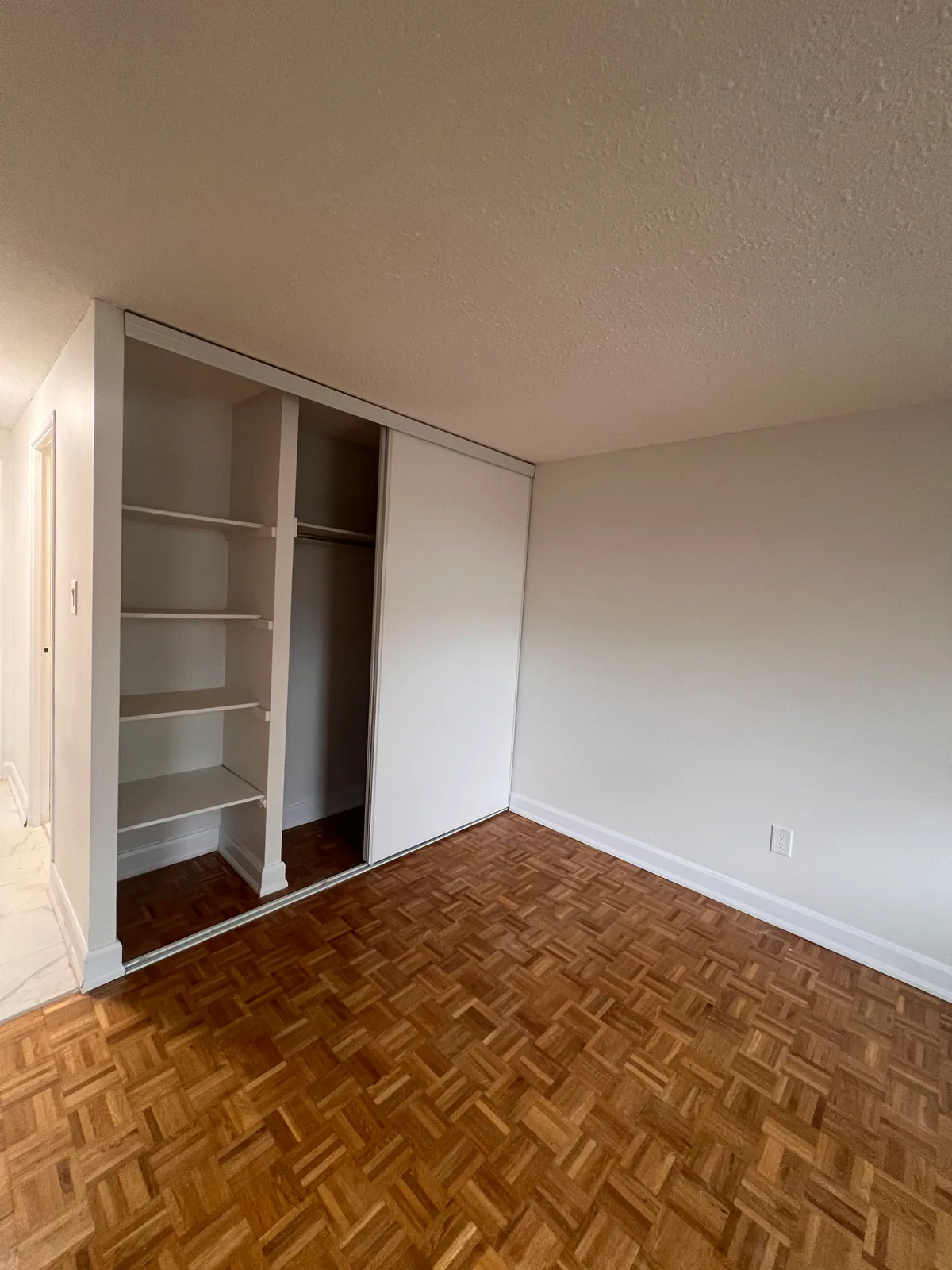 Completed closet storage with shelves and sliding door in the Goreway condo