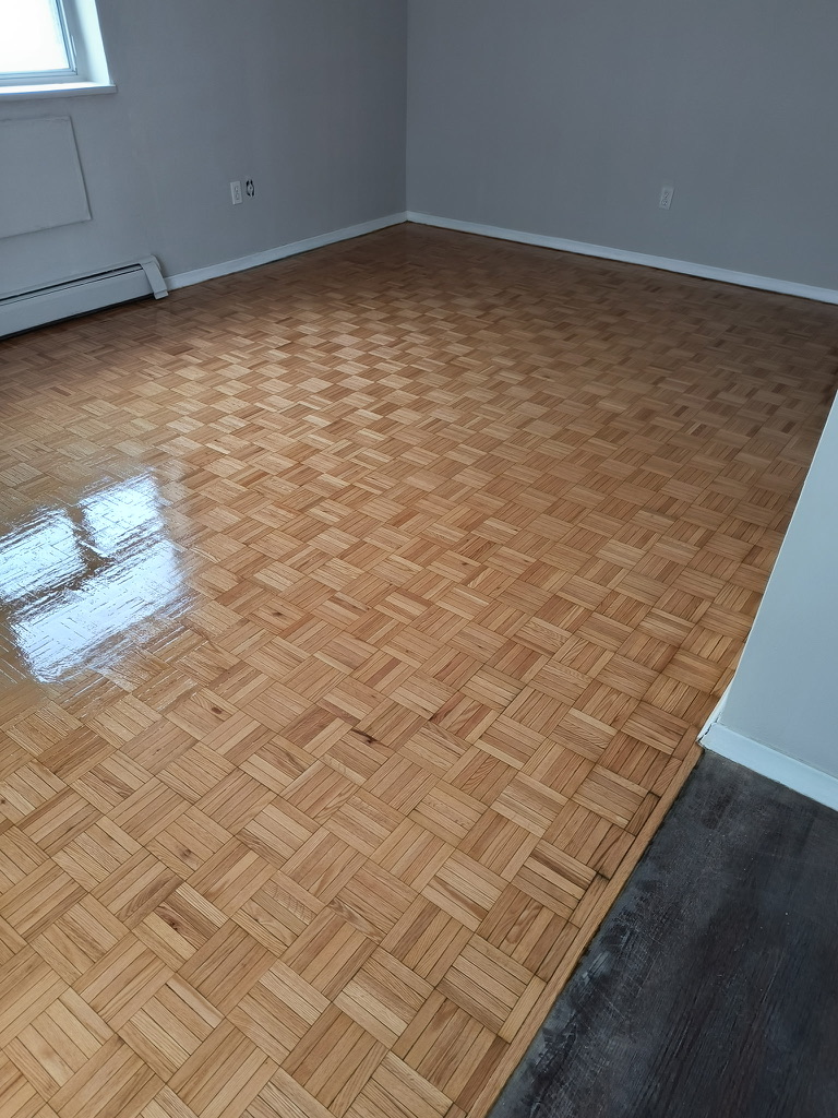 Wide room view of refinished parquet flooring in Hamilton Ontario
