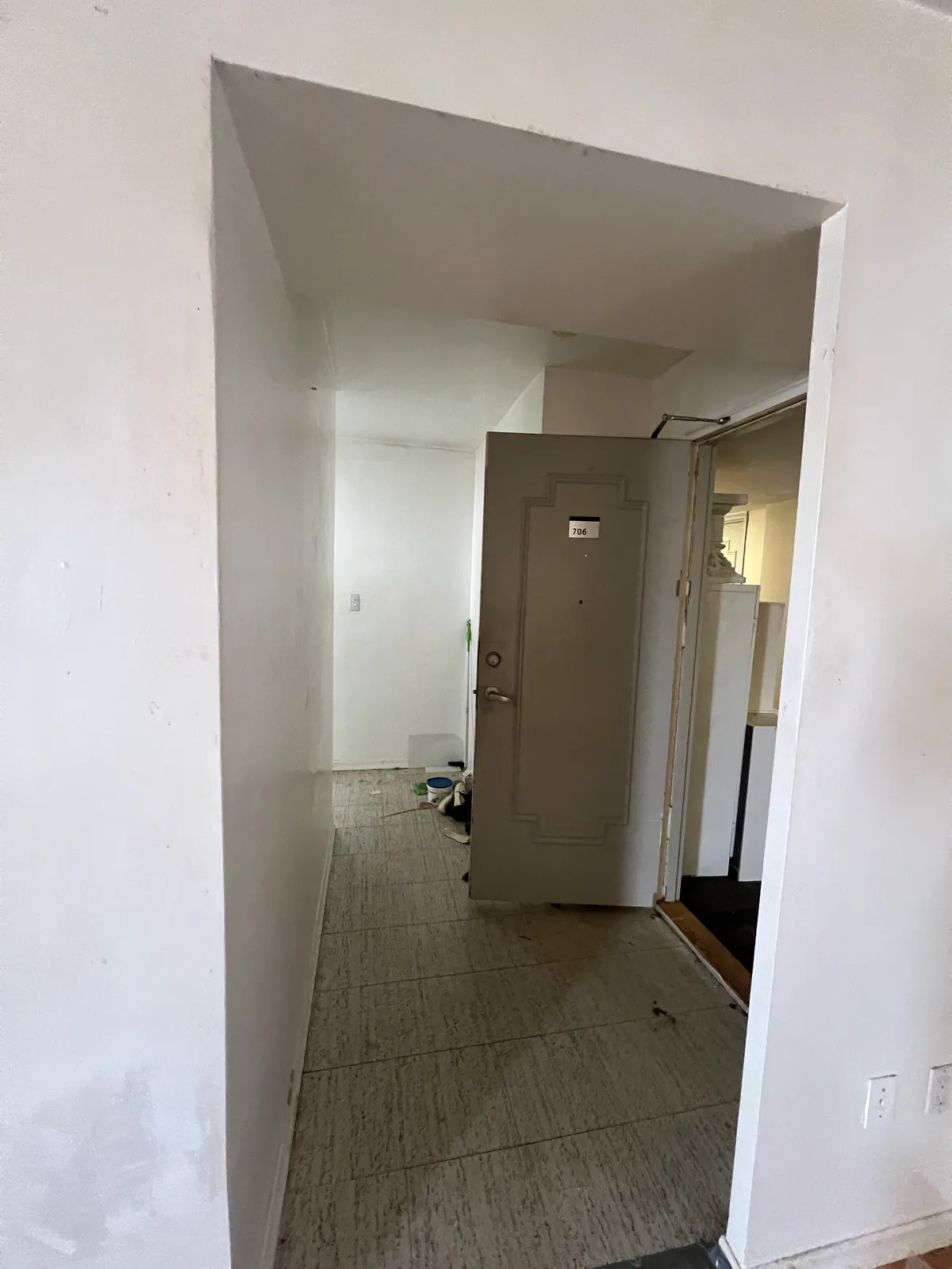 Corridor and doorway before the Bathurst apartment refresh