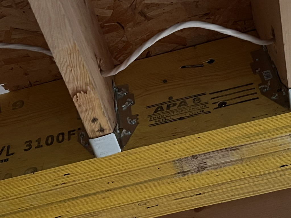 Close view of a wood beam and metal connection hardware