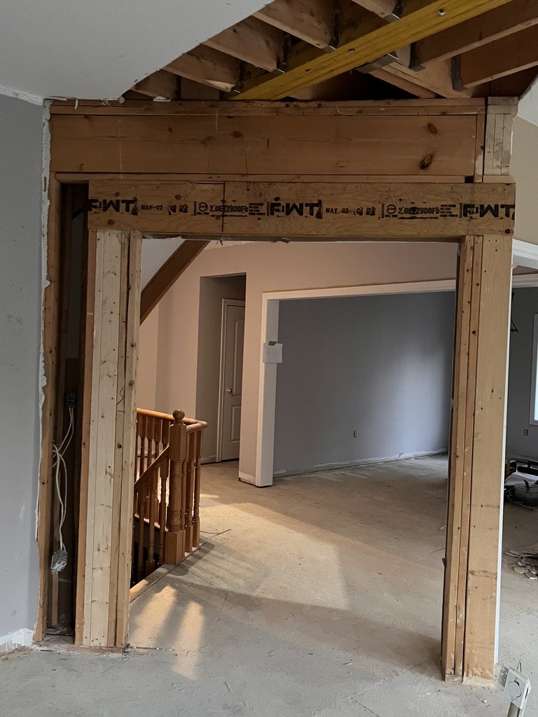 Rough wall opening with header and supporting side framing