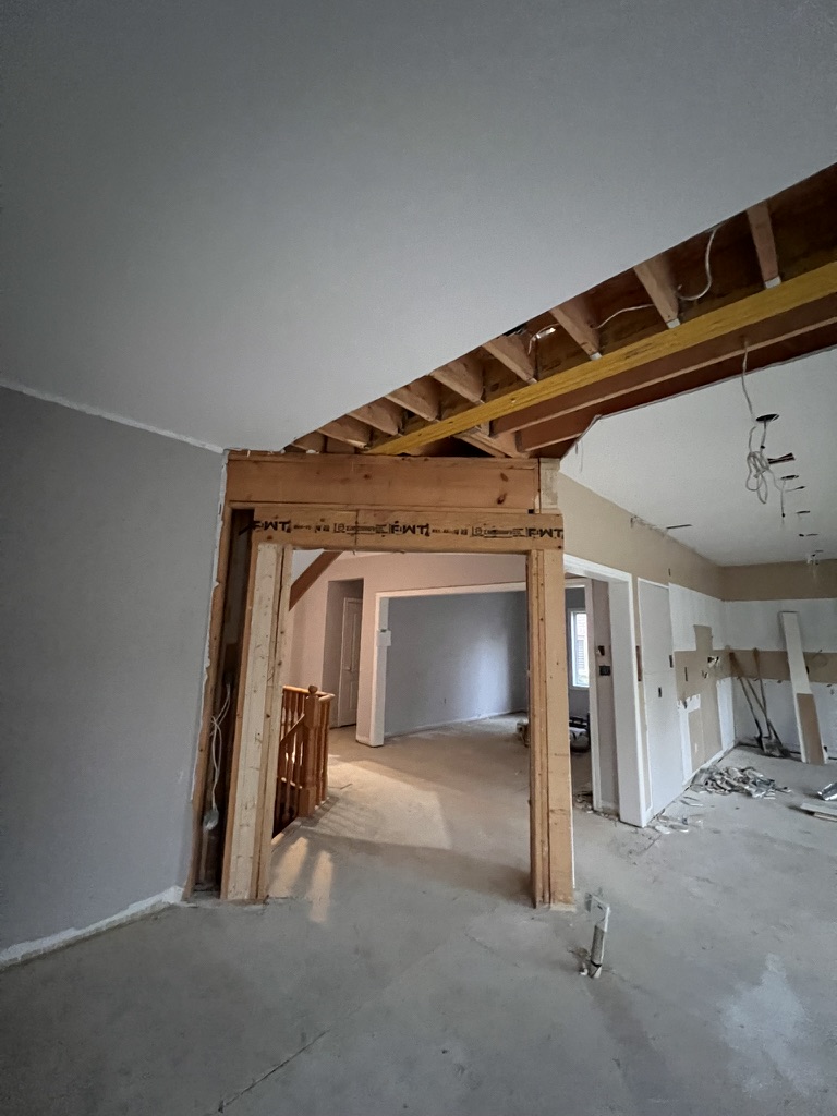 Open-concept work area with a framed opening before finishes