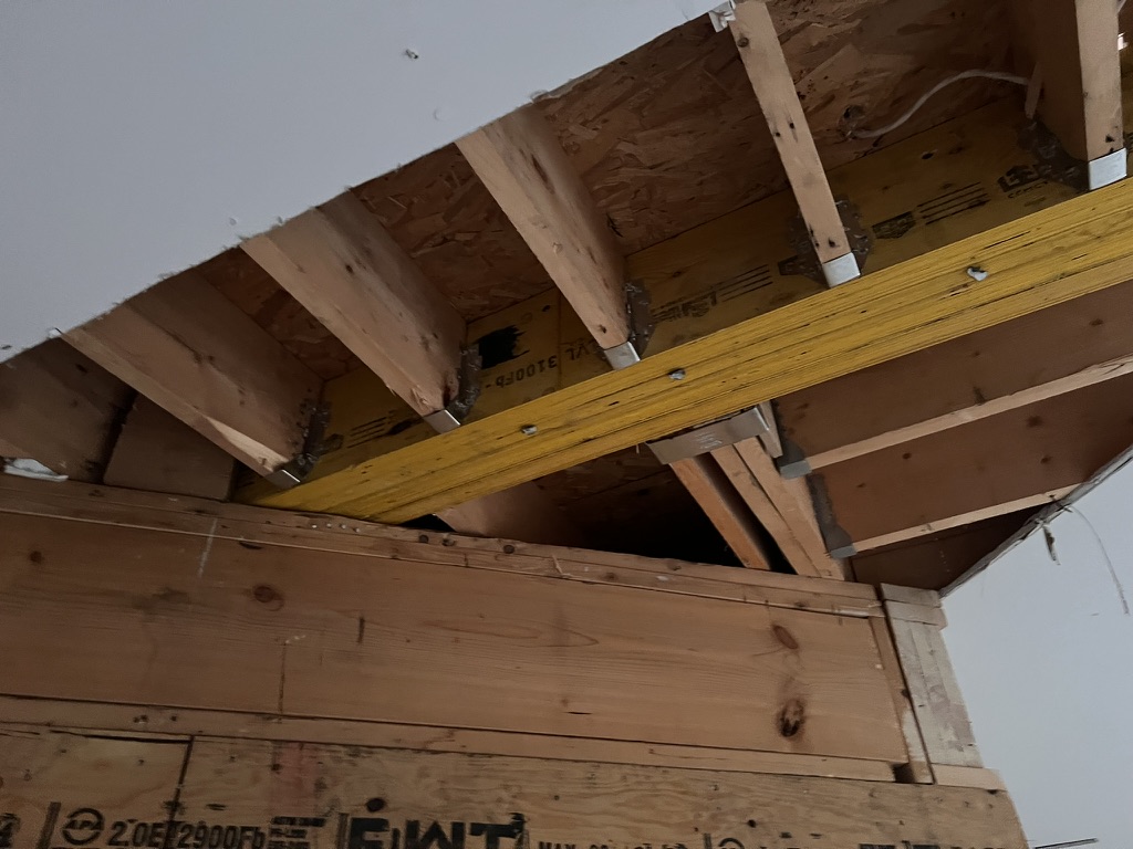 Beam and header connection meeting ceiling joists