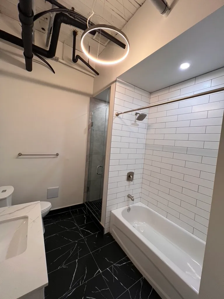 Completed 34 Noble bathroom with tiled shower and bathtub