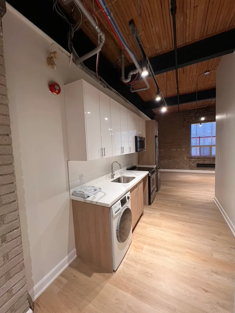 Completed 34 Noble kitchen wall with new cabinetry and counters