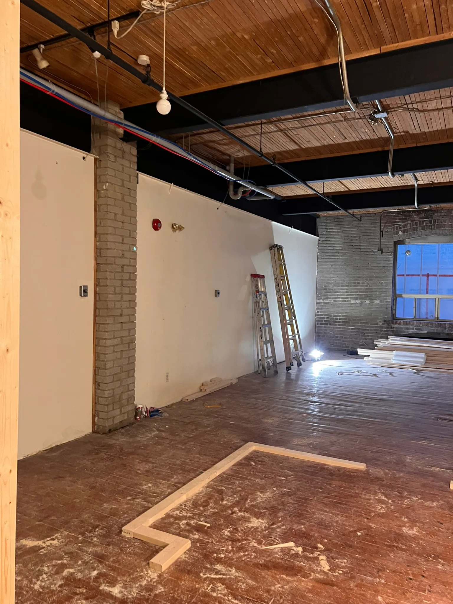 34 Noble interior under construction with exposed ceiling services
