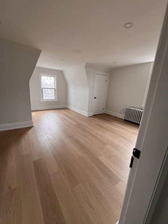 Finished upper-level living space with light wood flooring and fresh neutral paint
