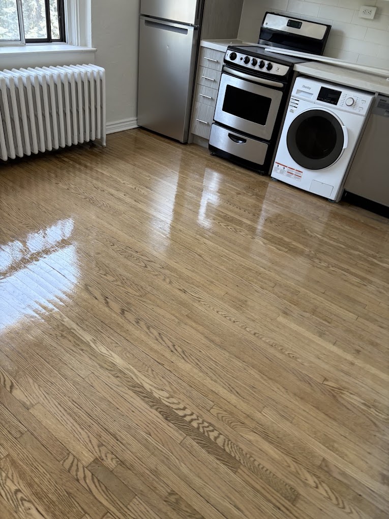 Kitchen and laundry area with refinished hardwood flooring and stainless appliances