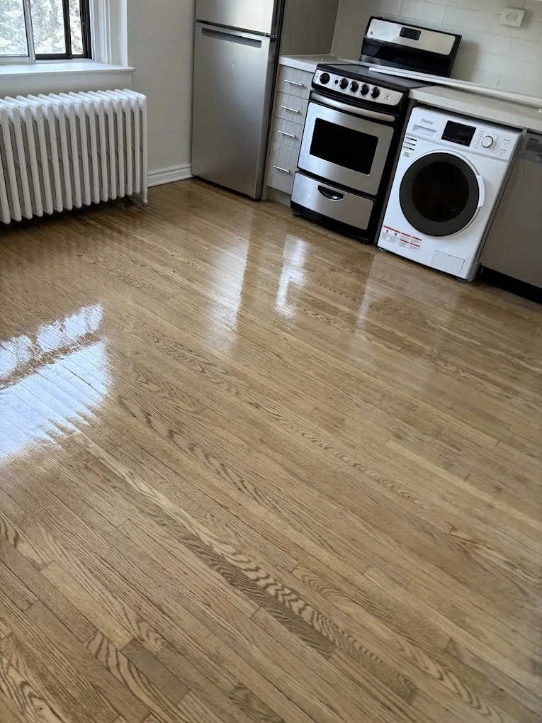 Kitchen and laundry area with refinished hardwood flooring and stainless appliances